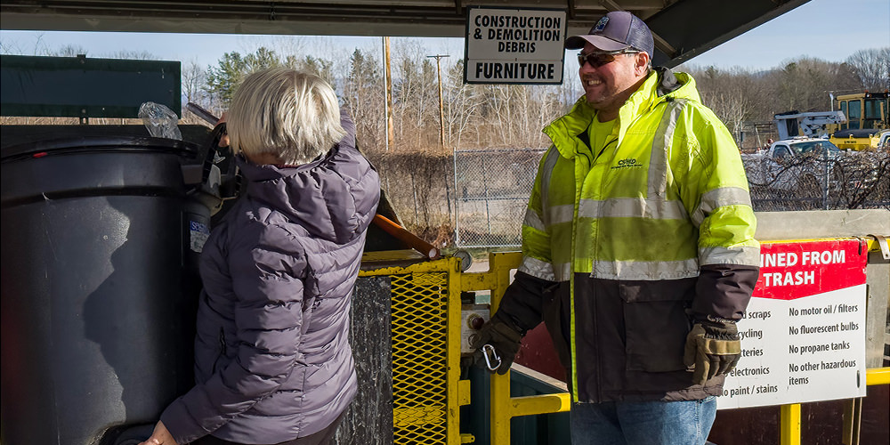 A Drop-Off Center Operator helps a customer with trash the Drop-Off Center in South Burlington.